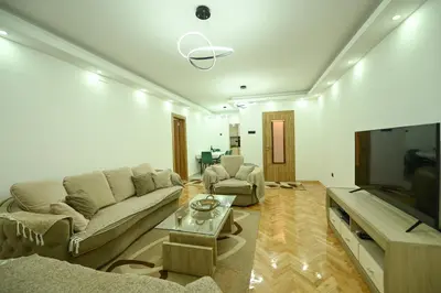 a living room with a couch and a flat screen tv at Apartman Oskar in Podgorica