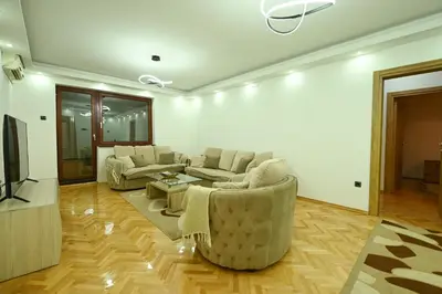 a living room with two couches and a tv at Apartman Oskar in Podgorica