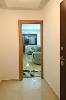 a view of a living room with a couch through a door at Apartman Oskar in Podgorica