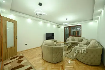 a living room with two couches and a tv at Apartman Oskar in Podgorica