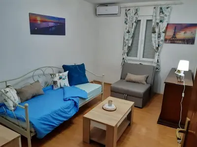 a living room with a couch and a table at Apartman Paris in Podgorica
