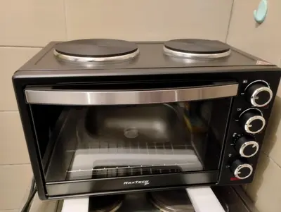 a black toaster oven sitting on top of a counter at Apartman Paris in Podgorica