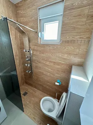 a small bathroom with a toilet and a window at Stex Urban 2 in Podgorica