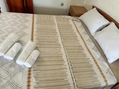 a bed with two pillows on top of it at Apartments Airport Golubovci in Podgorica