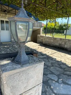 a street light sitting on top of a stone block at Apartments Airport Golubovci in Podgorica