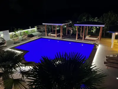 a swimming pool lit up in blue at night at Villa 100 Palme in Ulcinj