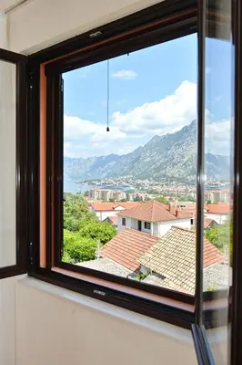 a window with a view of a city at Fjordfront Aerie in Kotor