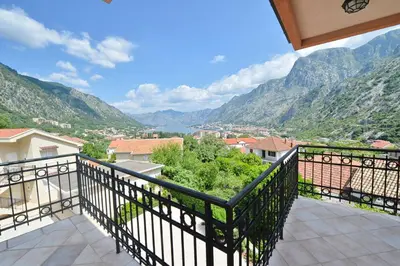 a balcony with a view of the mountains at Fjordfront Aerie in Kotor