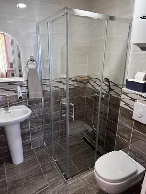 a bathroom with a shower and a toilet and a sink at Apartments Blanco in Budva