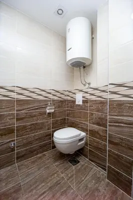 a bathroom with a toilet and a large light at Apartments Blanco in Budva