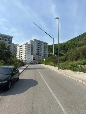 a car parked on the side of a road with a building at Becici - apartment Majestic in Budva