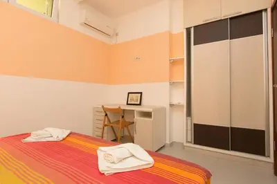 a bedroom with a bed with towels on it at Apartments Aleksandra in Podgorica
