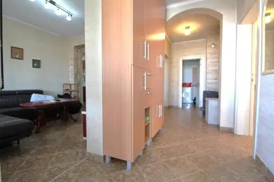 a hallway with a living room with a couch and a table at 2bd Apt w Private Pool and City View 
