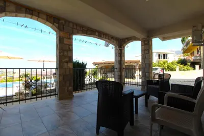a patio with chairs and a table with a view at 2bd Apt w Private Pool and City View 