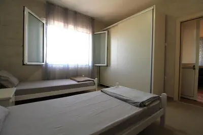 a bedroom with two beds and a window at 2bd Apt w Private Pool and City View 