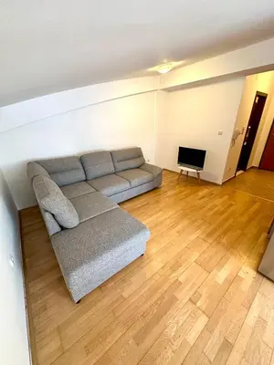 a living room with a couch and a television at Stex Urban 3 in Podgorica