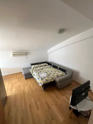 a living room with a couch and a tv at Stex Urban 3 in Podgorica
