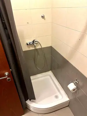 a bathroom with a shower with a white tub at Stex Urban 3 in Podgorica