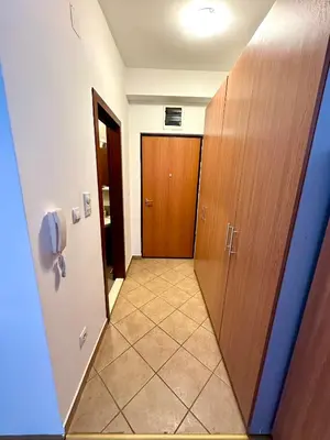 a hallway with a door and a tile floor at Stex Urban 3 in Podgorica