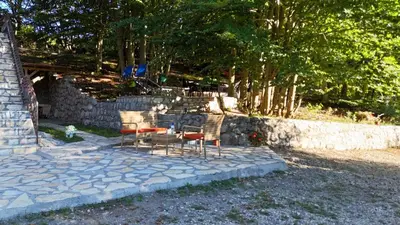 a table and chairs sitting on a stone patio at Vikendica Silenzio in Cetinje