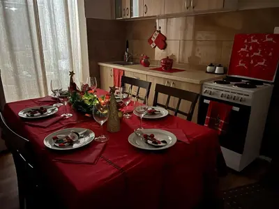 a kitchen with a table with a red table cloth at Vikendica Silenzio in Cetinje