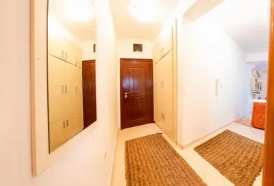 a hallway with two mirrors and a hallway with rugs at Studio Slavica in Budva