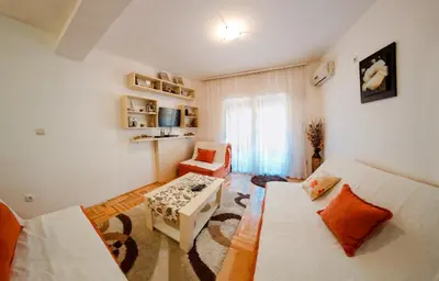 a living room with a couch and a chair at Studio Slavica in Budva
