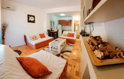 a living room with a couch and a table at Studio Slavica in Budva