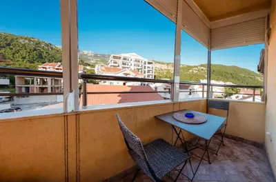 a balcony with a table and chairs and a view at Studio Slavica in Budva