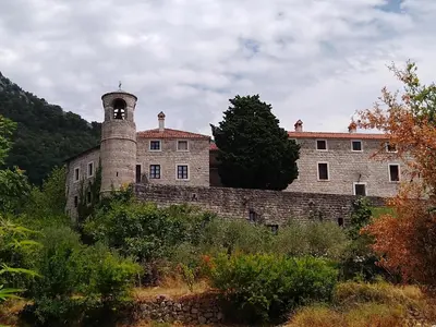 an old stone building with a bell tower on a hill at Studio Slavica in Budva
