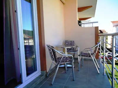 a balcony with chairs and a table and a window at Apartments Nedovic-Jaz in Budva