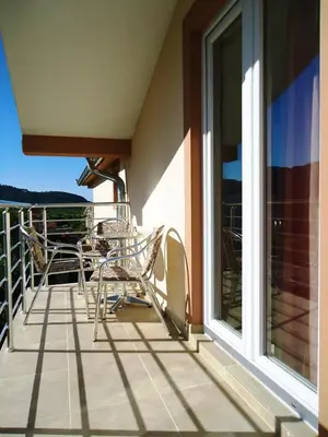 a balcony with chairs and a table and a window at Apartments Nedovic-Jaz in Budva