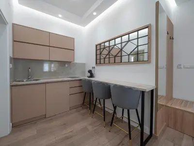 a kitchen with a counter and bar stools at Apartments Mary in Budva