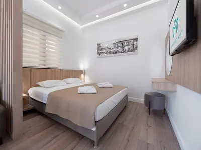 a bedroom with a bed and a television in it at Apartments Mary in Budva
