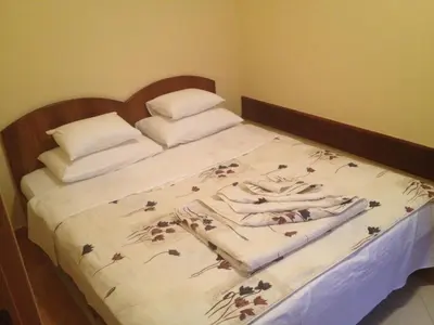 a bedroom with a bed with flowers on it at Blue Palace Guest House in Budva
