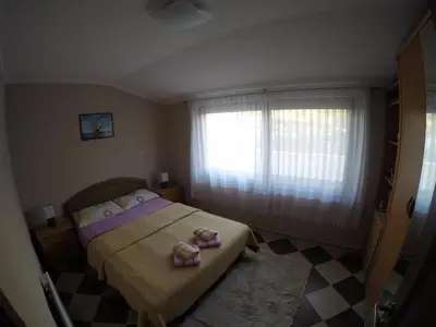 a bedroom with a bed with two towels on it at Apartments Krivokapic in Kotor