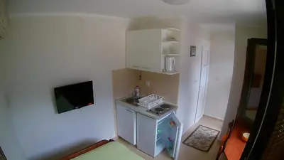 a small kitchen with a sink and a refrigerator at Apartments Krivokapic in Kotor