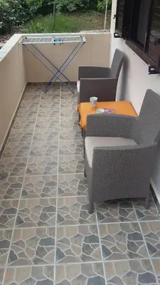 two chairs and a table on a patio at Apartments Krivokapic in Kotor