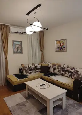 a living room with a couch and a table at CITY POINT Apartment in Podgorica