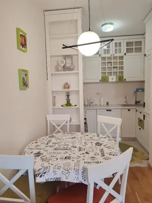 a kitchen with a table and two chairs and a dining room at CITY POINT Apartment in Podgorica