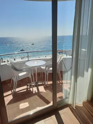 a balcony with a table and a view of the ocean at Apartments Val in Dobra Voda