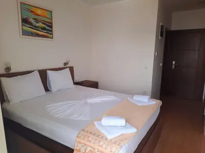 a bedroom with a bed with two towels on it at Apartments Val in Dobra Voda