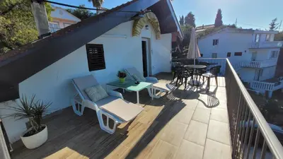 a balcony with a table and chairs and a patio at Apartment Old Olive in Dobra Voda
