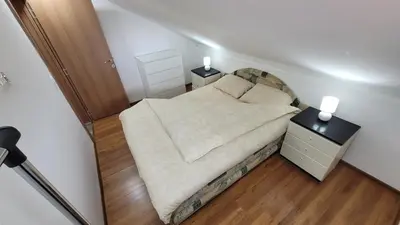 a small bedroom with a bed and two night stands at Apartment Old Olive in Dobra Voda