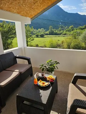 a living room with a table with a bowl of food on it at Sunny Valley in Bar