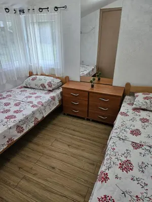 a room with two beds and a dresser in it at Sunny Valley in Bar