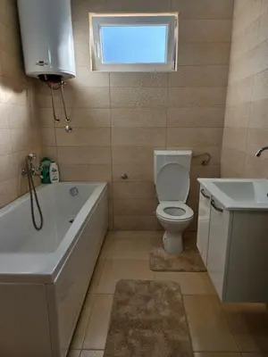 a bathroom with a toilet and a tub and a sink at Sunny Valley in Bar