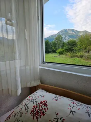 a bedroom with a window looking out at a mountain at Sunny Valley in Bar