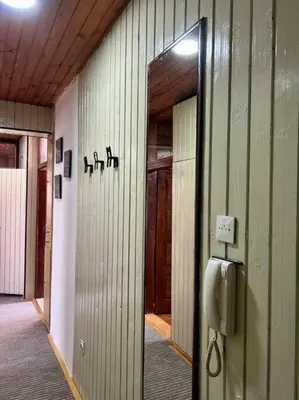 a hallway of a building with a pay phone at Central Park Apartment in Podgorica