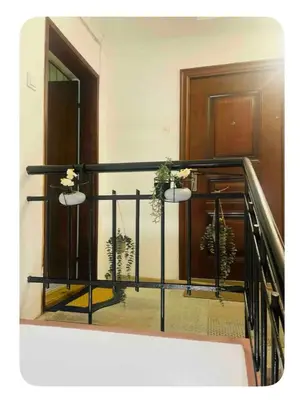 a stair railing with two lights and plants on it at Central Park Apartment in Podgorica